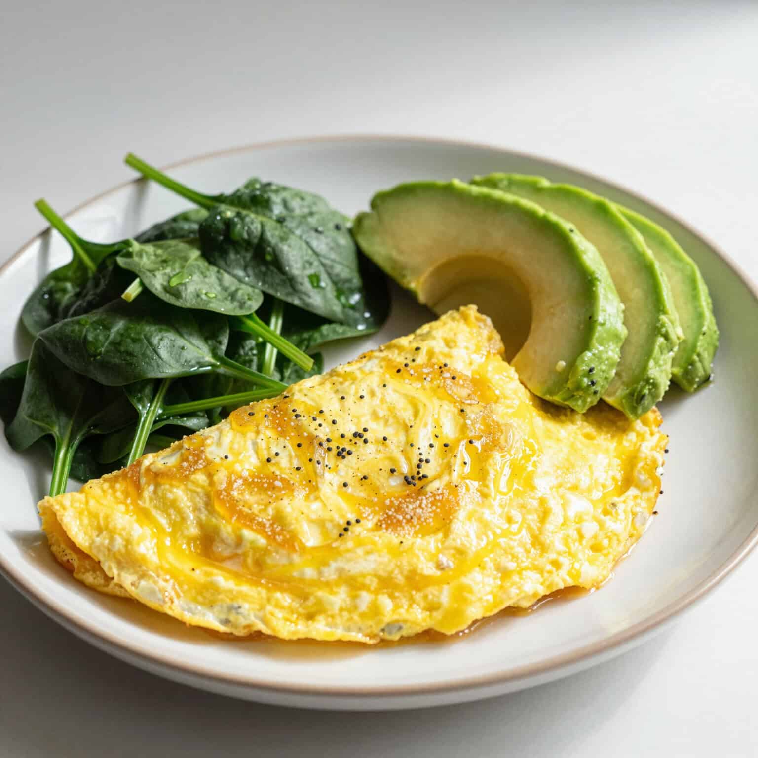 Omelette with spinach and avocado slices