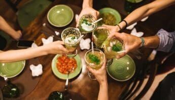 Refreshing green cocktails with mint and ice to promote health and wellness at a social gathering.