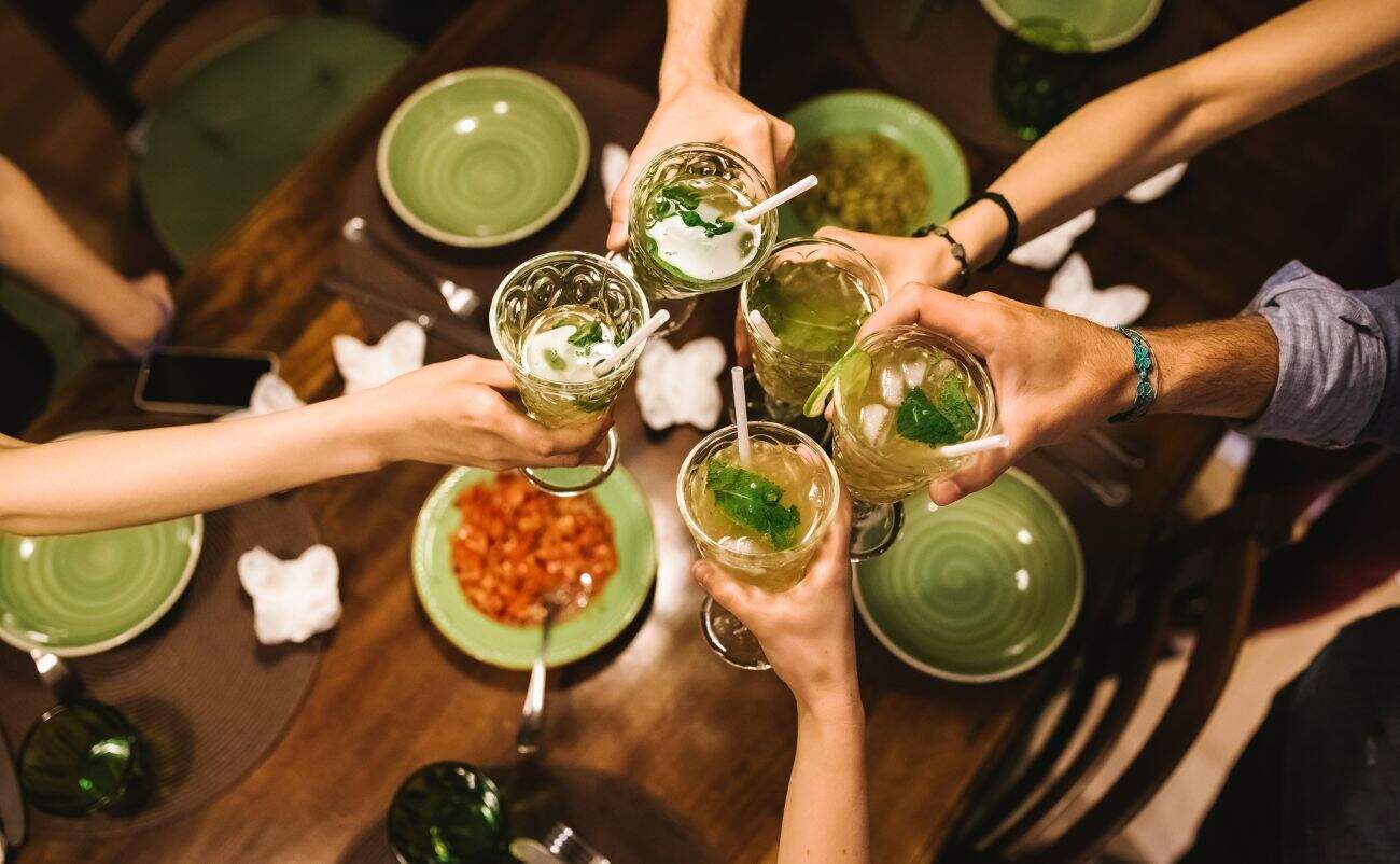 Refreshing green cocktails with mint and ice to promote health and wellness at a social gathering.