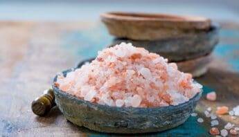 Himalayan Pink Salt Weight Loss Recipe: Simple Detox Drink Guide 9 Himalayan pink salt in a rustic bowl with a wooden spoon, emphasizing natural health and wellness ingredients.