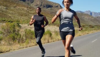 Running outdoors on scenic mountain road for fitness and health.