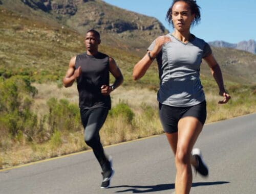Running outdoors on scenic mountain road for fitness and health.