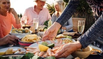 Fresh seafood and healthy food options shared during an outdoor gathering with friends, promoting balanced eating and social wellness.