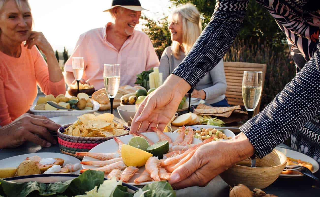 Fresh seafood and healthy food options shared during an outdoor gathering with friends, promoting balanced eating and social wellness.