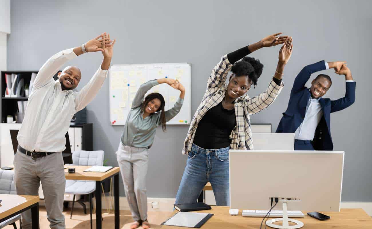 Deeply engage in stretching exercises during office break to promote health and reduce stress, demonstrating a healthy work environment and lifestyle.