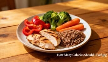 Broccoli, carrots, red bell peppers, grilled chicken, and brown rice on a white plate, healthy balanced meal for fitness and nutrition.