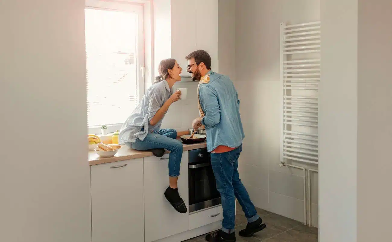 Young couple enjoying breakfast together in a bright kitchen, promoting healthy lifestyle and balanced diet.