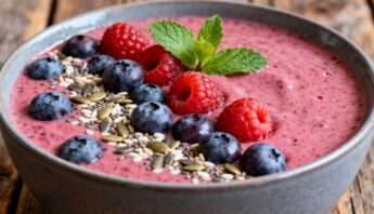 Healthy Drink Smoothie Easy Nutritious Blends You’ll Actually Crave 13 Fresh berry smoothie bowl topped with blueberries, raspberries, chia seeds, flax seeds, and a sprig of mint, served in a rustic ceramic bowl on a wooden surface.