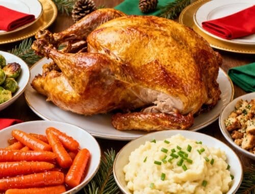 A delicious roasted turkey served with mashed potatoes, carrots, Brussels sprouts, stuffing, and cranberry sauce, ideal for holiday celebrations.