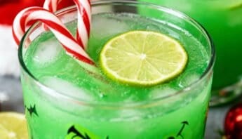 Refreshing holiday-themed green beverage with lime and candy canes.