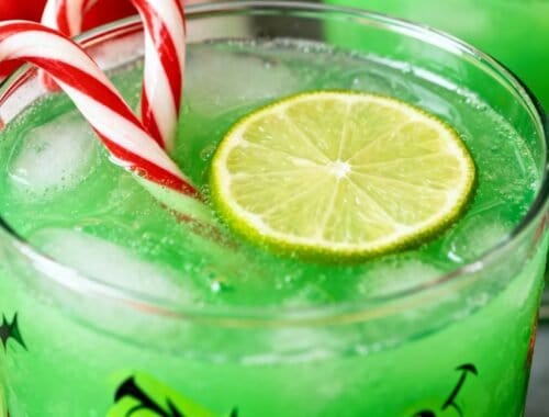 Refreshing holiday-themed green beverage with lime and candy canes.