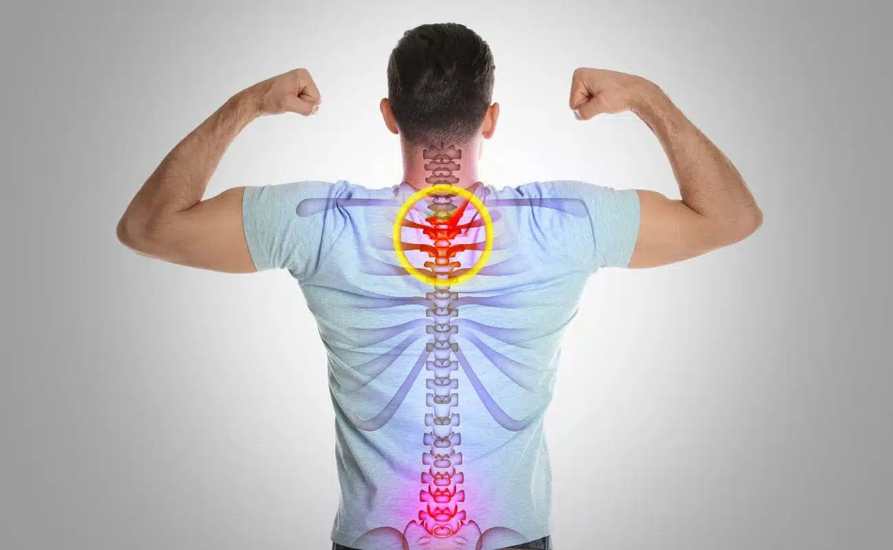 Back view of a man flexing muscles with an illustrated spine and neck pain highlighted in red and yellow, indicating back health awareness.
