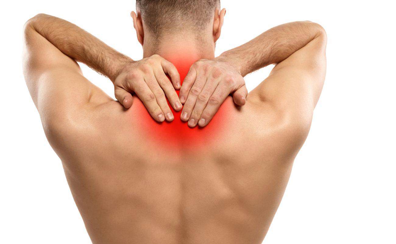 Red and irritated neck and shoulder pain, man massaging his upper back with focus on inflammation or discomfort.