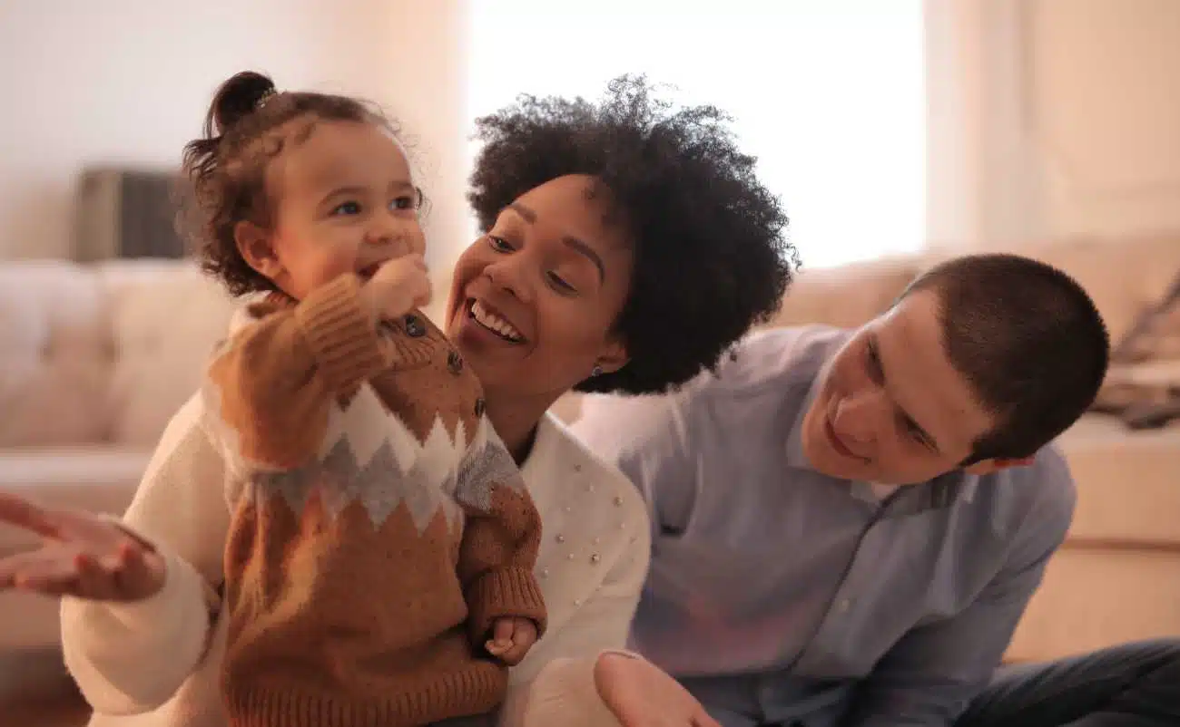 Happy family enjoying quality time together on a cozy living room sofa, promoting health and wellness through family bonding and positive mental health.