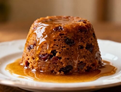 Delicious caramelized fruit cake drizzled with rich caramel sauce, served on a floral plate, highlighting a sweet treat that can fit into balanced diet plans.