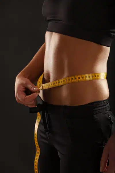 Women measure belly for belly fat loss exercise