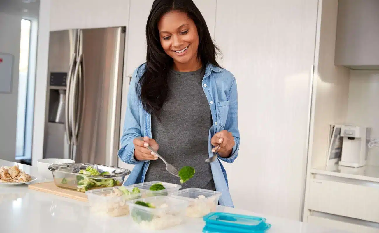 Fresh healthy meal prep with vegetables in glass containers in a modern kitchen.