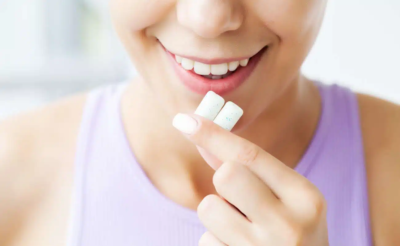 Vitamin supplements, smiling woman taking vitamins, health and wellness, close-up of woman holding pills, personal health care lifestyle.